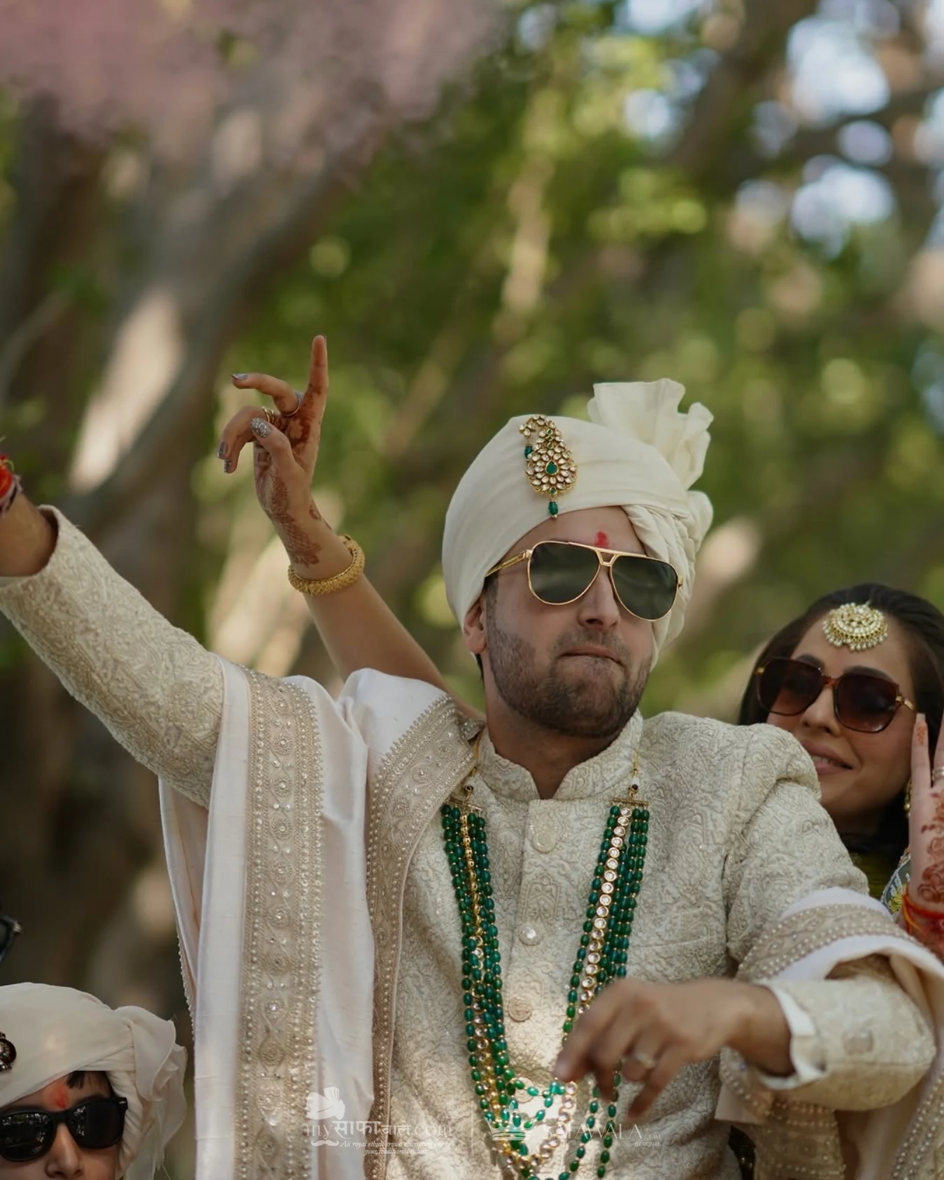 Groom in an ivory wedding safa with emerald jewellery for Bhilad
